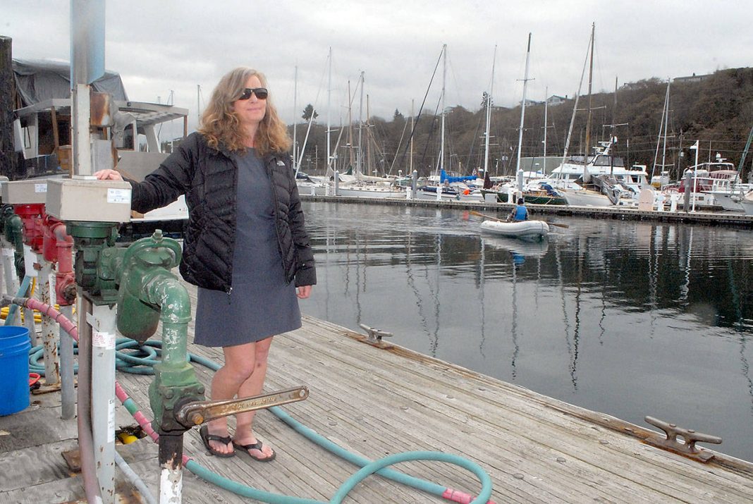 Port Angeles Yacht Club Commodore Erika Hansen-Dahlin stands on the Port Angeles Boat Haven fuel dock, a feature destined to be replaced as part of $2.1 million in improvements approved by the Port of Port Angeles. (Keith Thorpe/Peninsula Daily News)