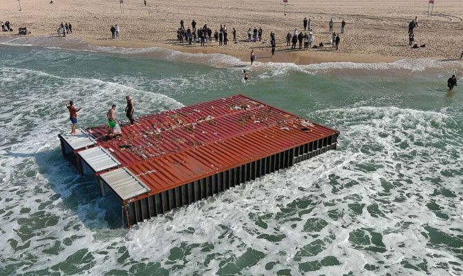 9 containers overboard, locals loot beached goods